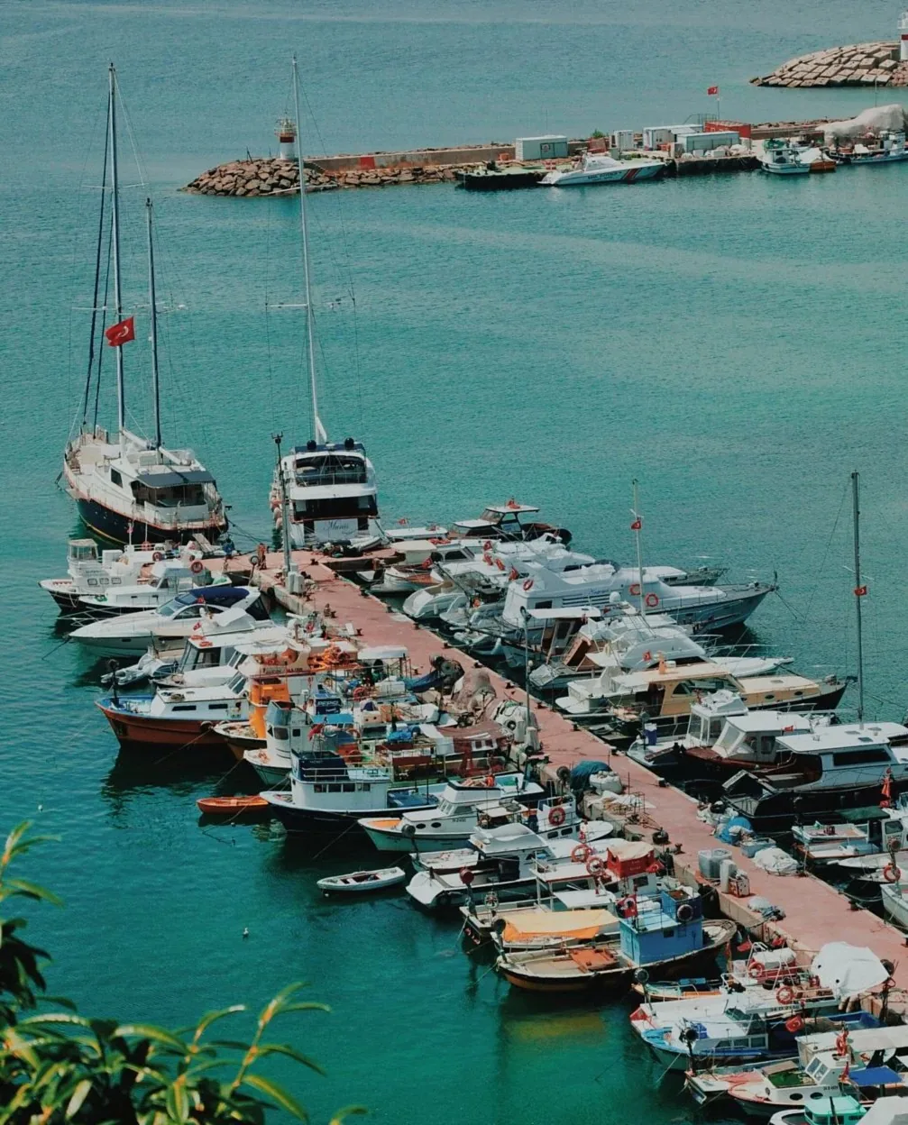 Wooden dock with small boats moored on a large northern lake